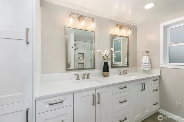 a bathroom with double sink and a mirror