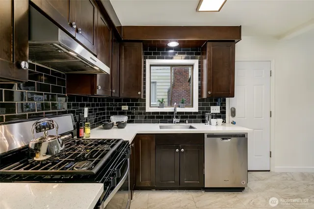 a kitchen with a sink and wooden cabinets