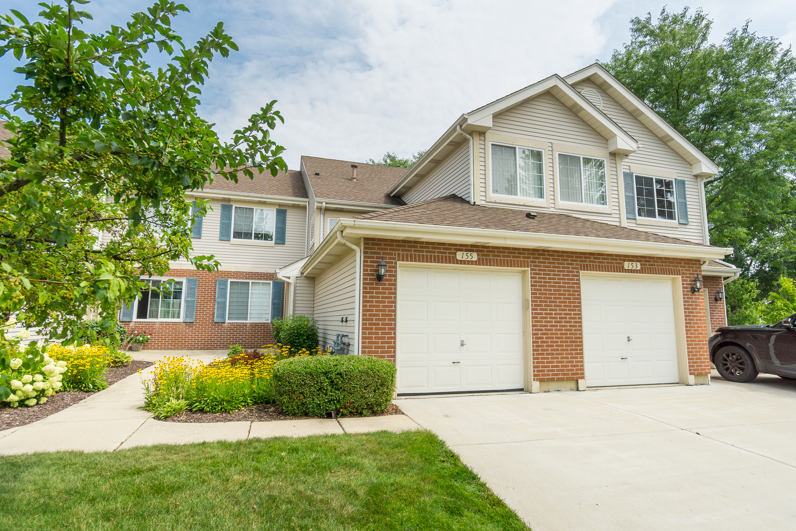 a front view of a house with a yard and garage