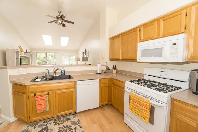 a kitchen with stainless steel appliances granite countertop a sink stove and cabinets
