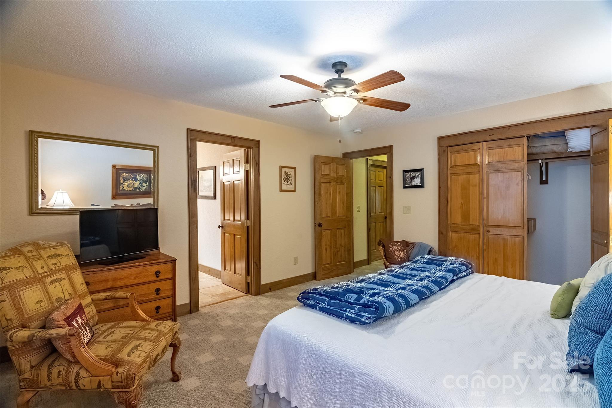 620 Sapphire Valley Road Sapphire, NC 28774 - Photo 25 of 48 a bedroom with a bed and a flat screen tv