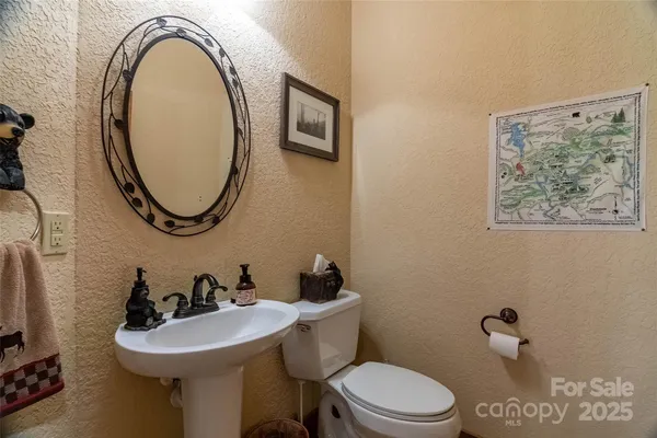 a bathroom with a sink mirror and toilet