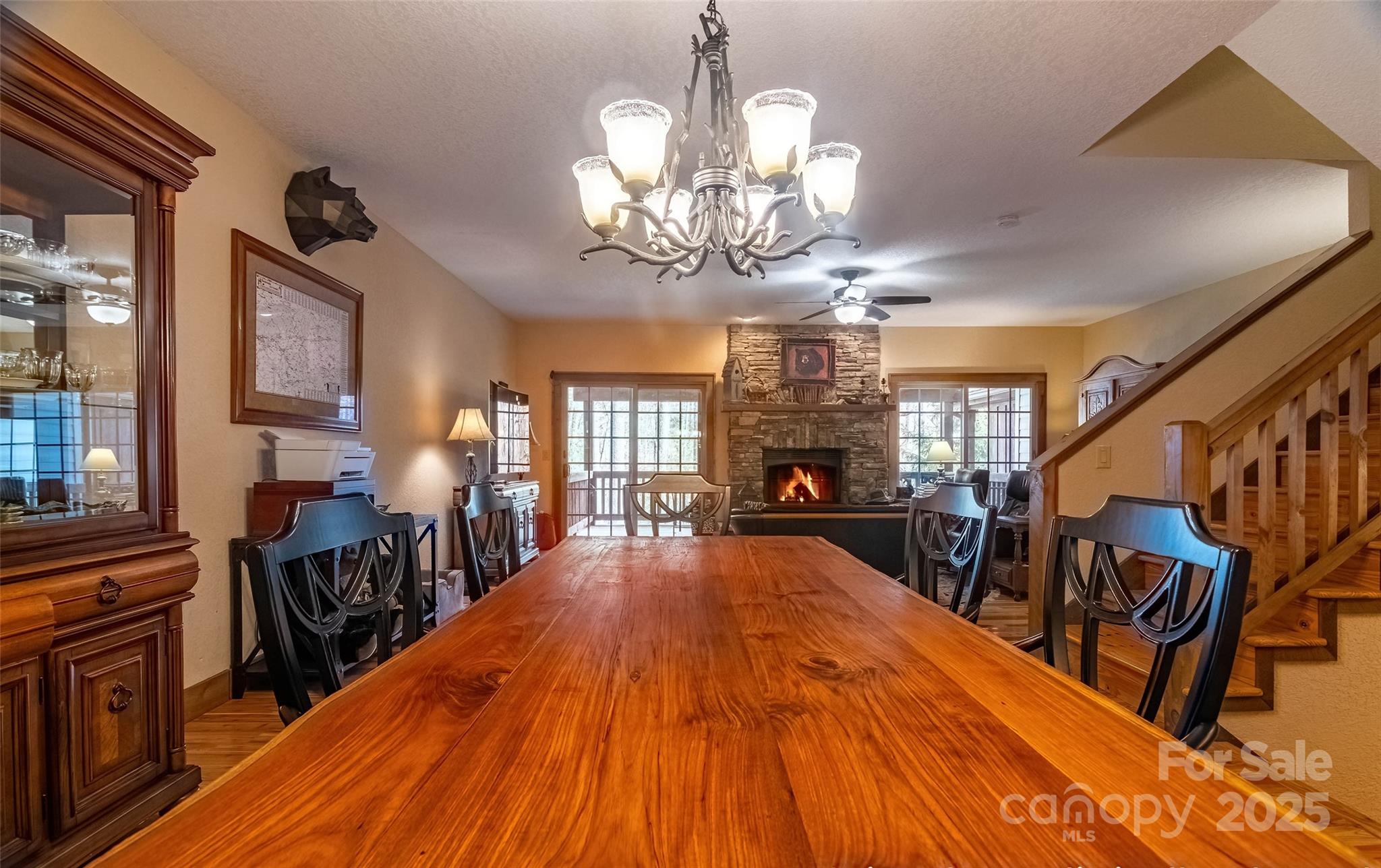 620 Sapphire Valley Road Sapphire, NC 28774 - Photo 10 of 48 a view of a dining room with furniture a chandelier and wooden floor