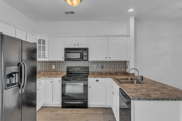 a kitchen with a sink stove and refrigerator