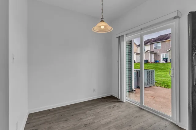 a view of a room with wooden floor and a porch
