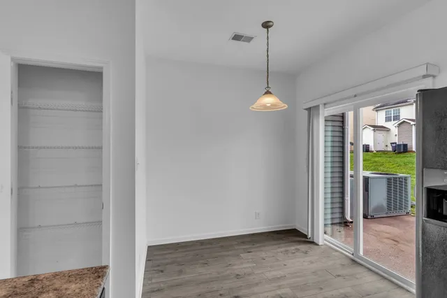 a view interior room with wooden floor and outdoor view