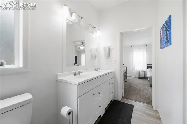 a en suite bathroom with a toilet sink and mirror