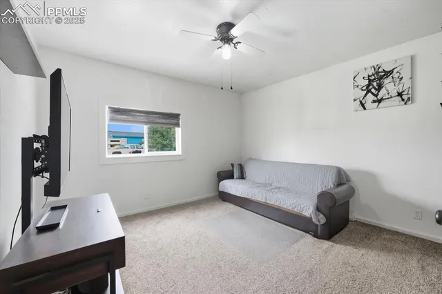 a living room with furniture and a desk