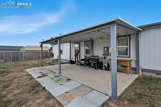 a view of a house with backyard porch and sitting area
