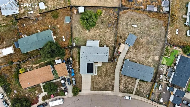 an aerial view of a house with a yard and outdoor seating