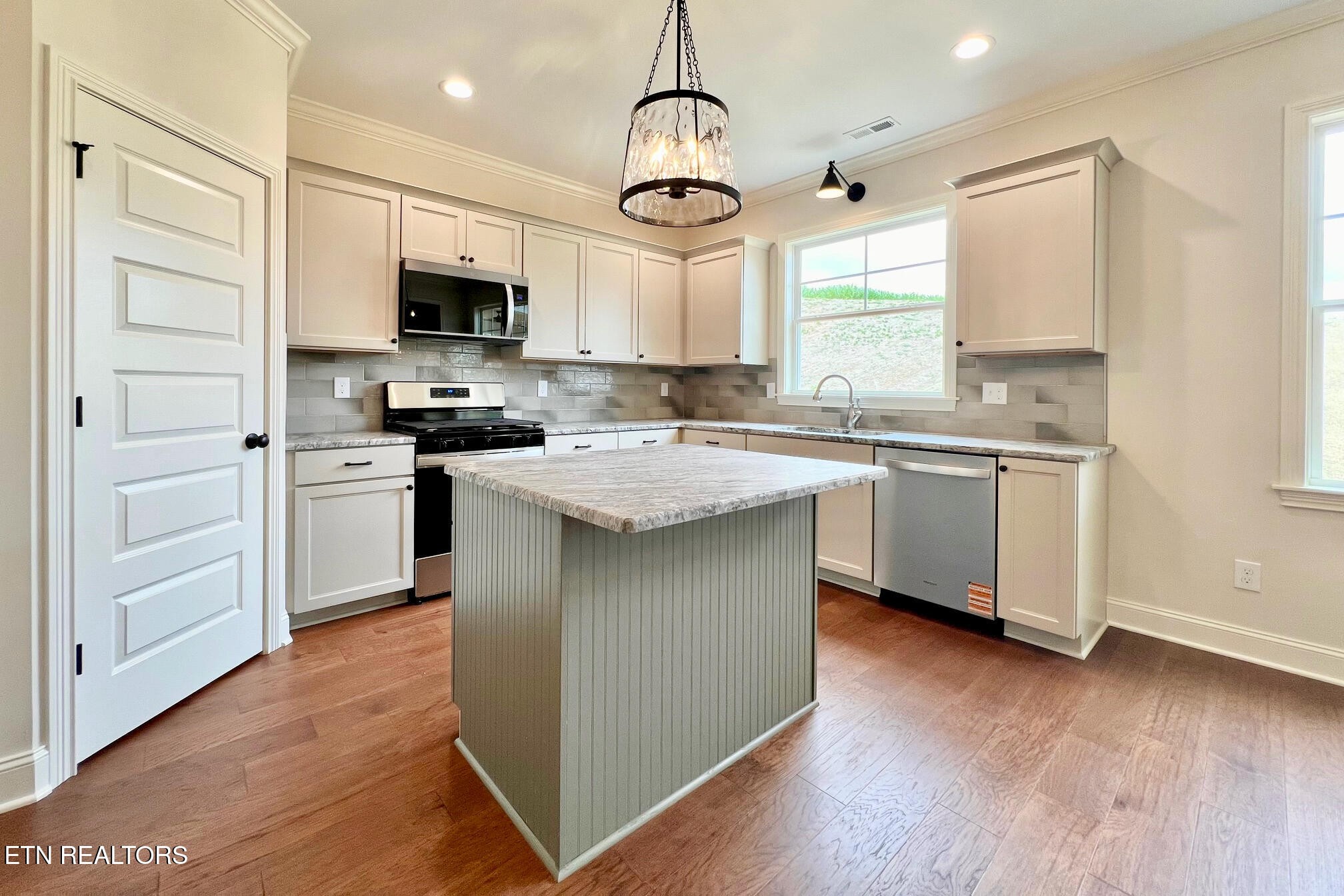 1209 Madison Oaks Road Knoxville, TN 37924 - Photo 16 of 35 a kitchen with stainless steel appliances stove a sink and a refrigerator
