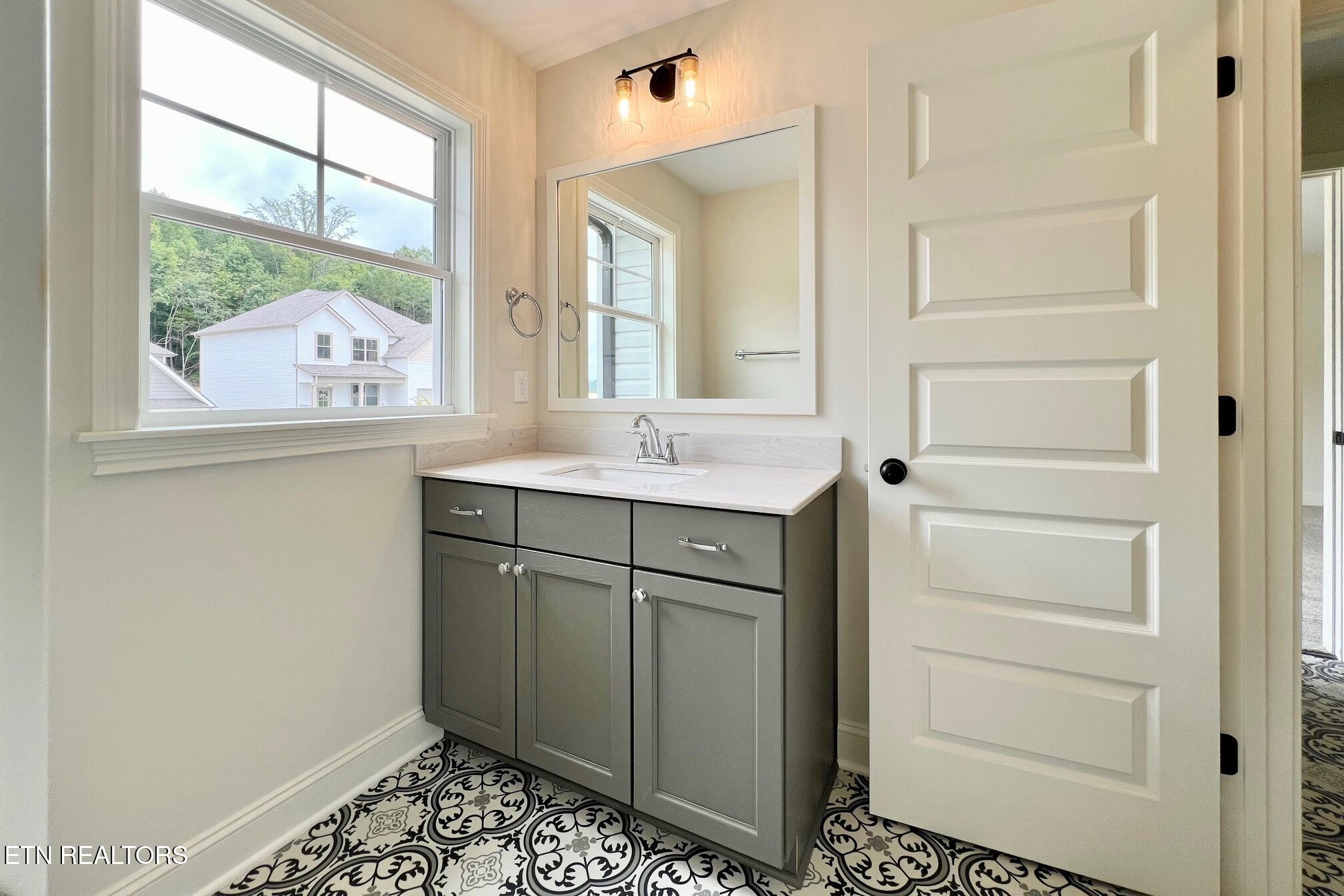 1209 Madison Oaks Road Knoxville, TN 37924 - Photo 26 of 35 a bathroom with a sink a vanity and a large mirror