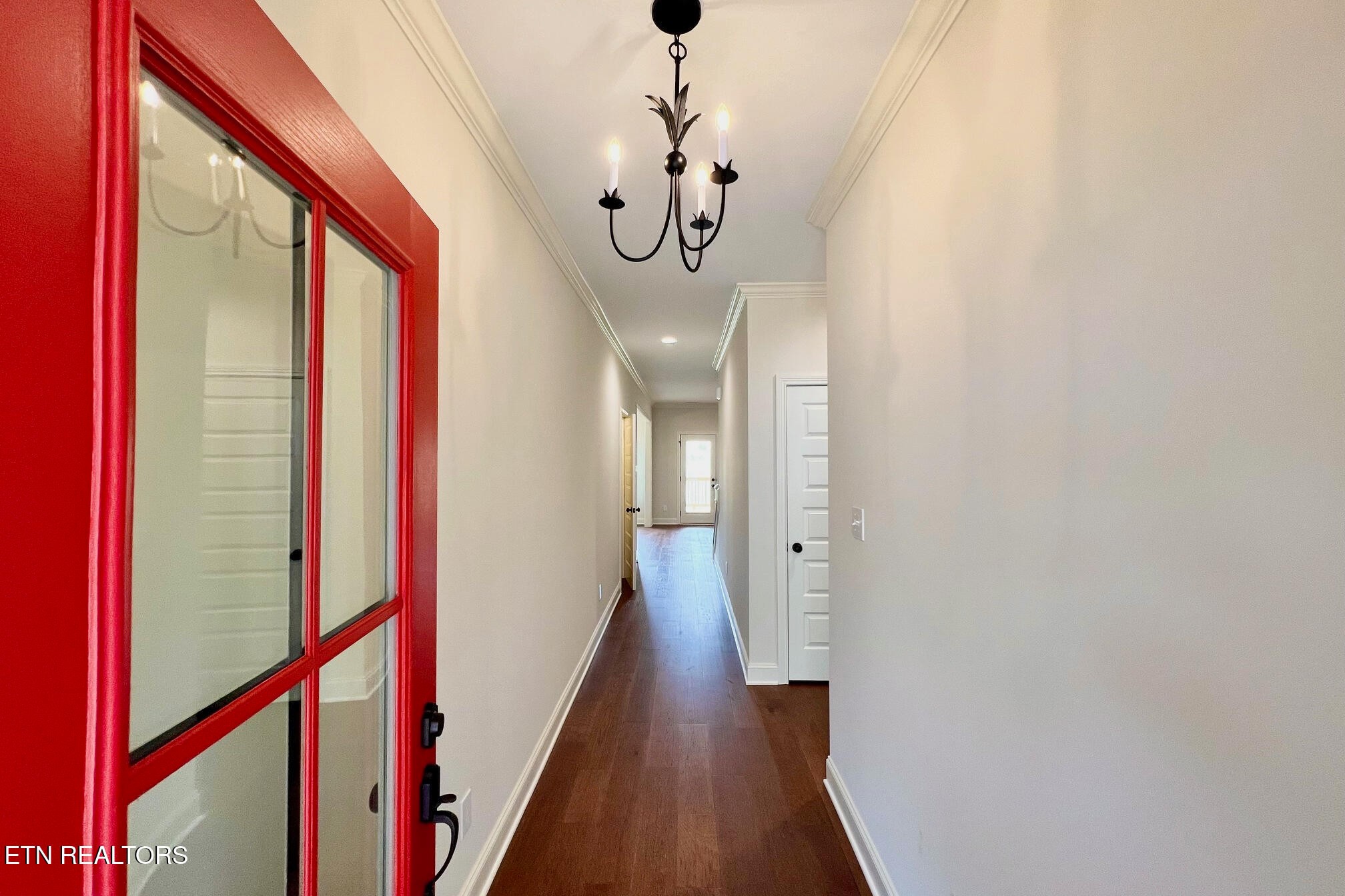 1209 Madison Oaks Road Knoxville, TN 37924 - Photo 3 of 35 a view of a hallway with wooden floor and windows