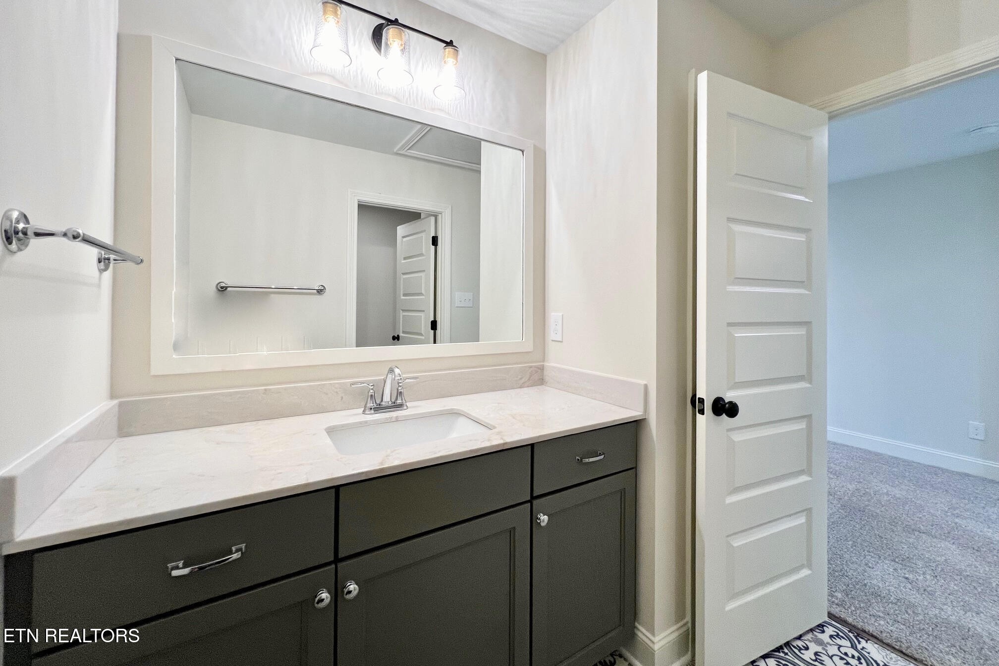 1209 Madison Oaks Road Knoxville, TN 37924 - Photo 31 of 35 a bathroom with a sink and a mirror