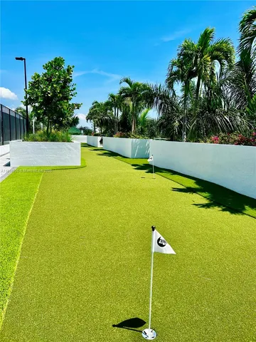 a view of a swimming pool and trees in the background