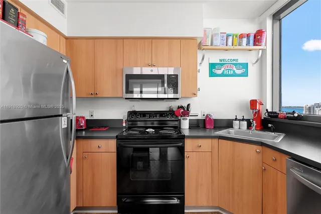 a kitchen with a sink stove and microwave