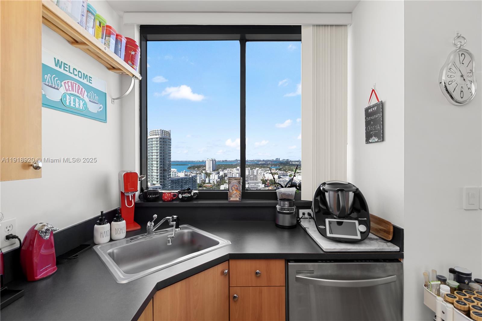 1330 West Avenue, Unit 2513 Miami Beach, FL 33139 - Photo 5 of 20 a kitchen with a sink stove and cabinets