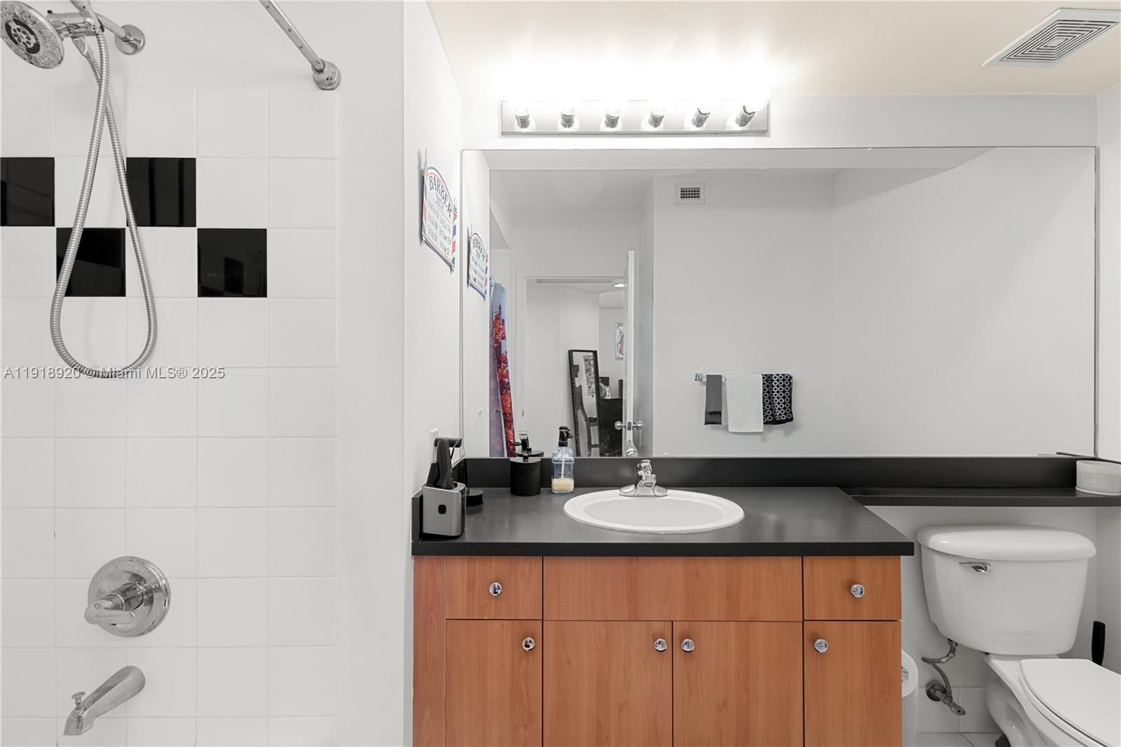 1330 West Avenue, Unit 2513 Miami Beach, FL 33139 - Photo 8 of 20 a bathroom with a sink and a mirror