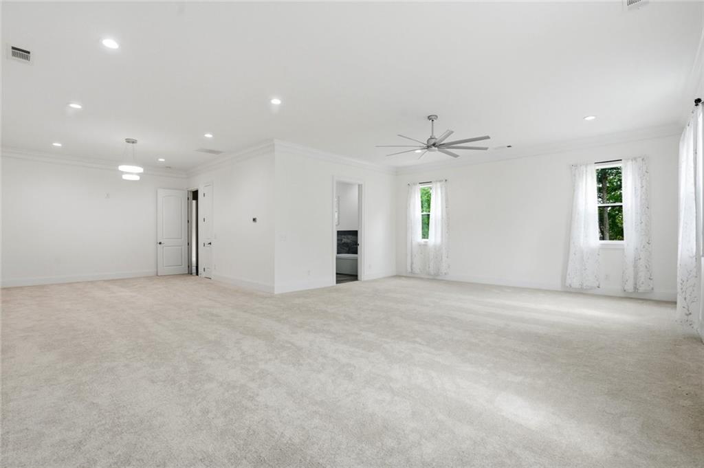 2415 West Rugby Avenue Atlanta, GA 30337 - Photo 14 of 40 an empty room with windows and ceiling fan