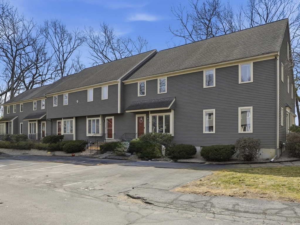 9 Deer Path, Unit 5 Maynard, MA 01754 - Photo 1 of 29 a front view of a house with a yard