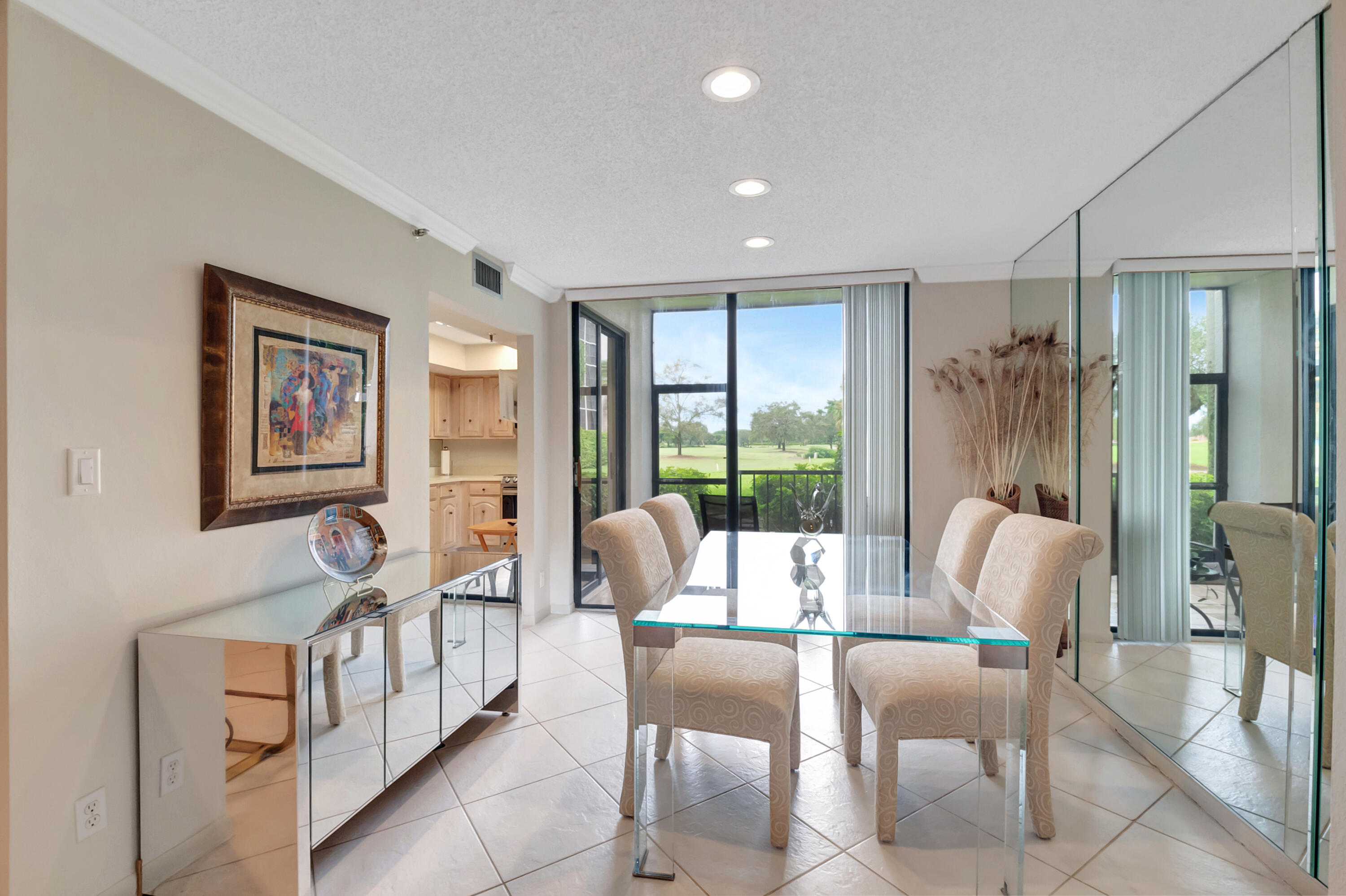 6805 Willow Wood Drive, Unit 5014 Boca Raton, FL 33434 - Photo 16 of 51 a dining room with furniture and large windows