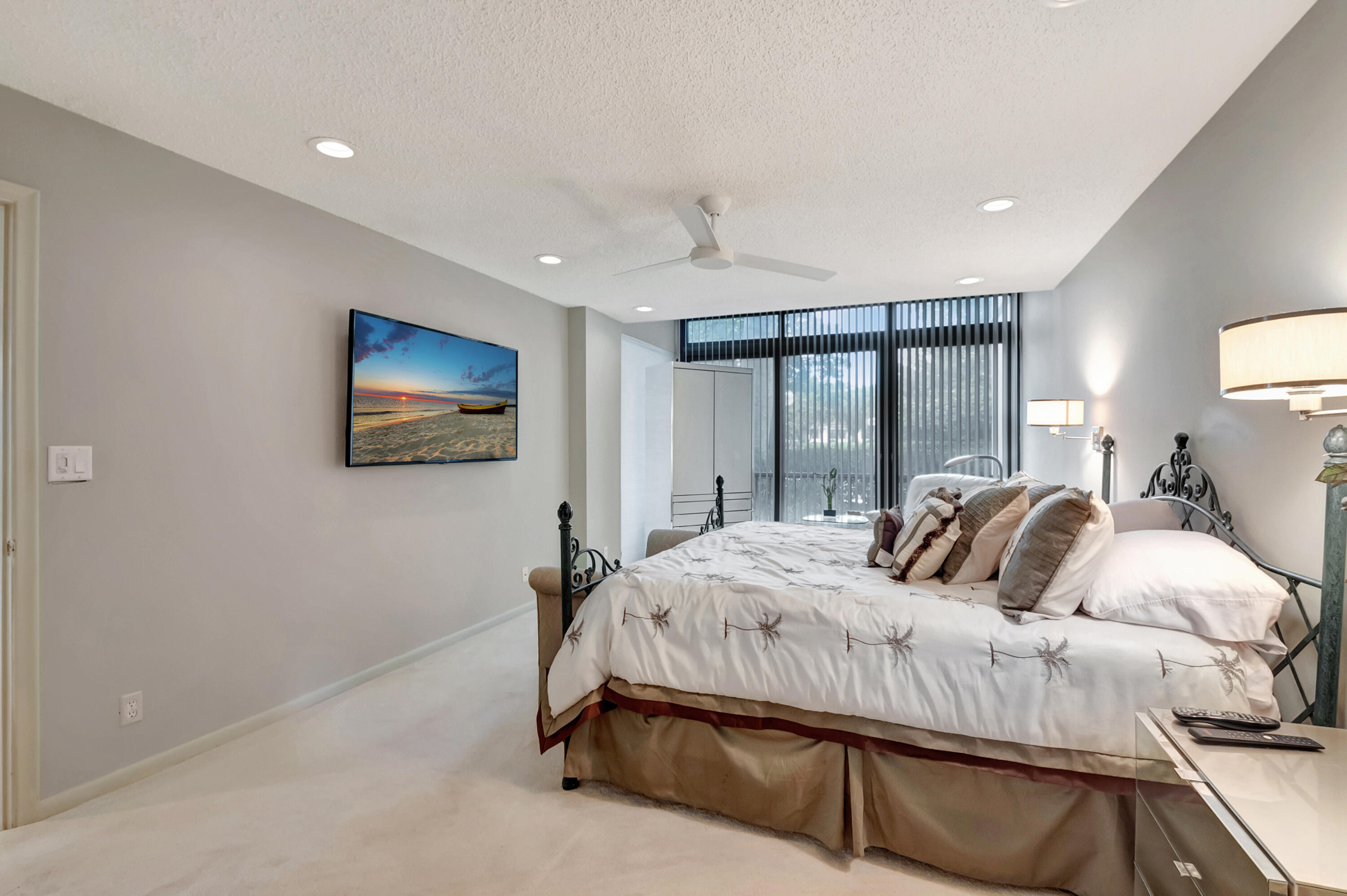 6805 Willow Wood Drive, Unit 5014 Boca Raton, FL 33434 - Photo 25 of 51 a bedroom with a bed and a night stand