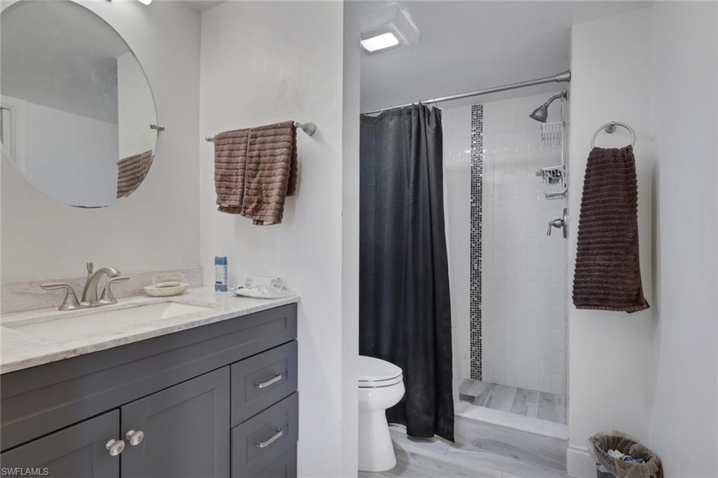 1211 Commonwealth Circle, Unit C201 Naples, FL 34116 - Photo 13 of 23 a bathroom with a sink toilet and shower