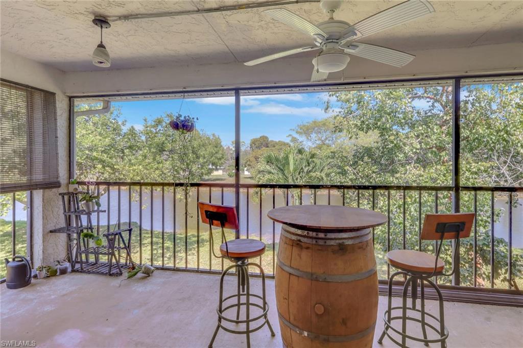 1211 Commonwealth Circle, Unit C201 Naples, FL 34116 - Photo 16 of 23 a balcony with table and chairs