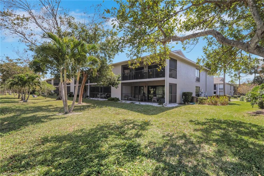 1211 Commonwealth Circle, Unit C201 Naples, FL 34116 - Photo 17 of 23 a view of house with outdoor space and tree s