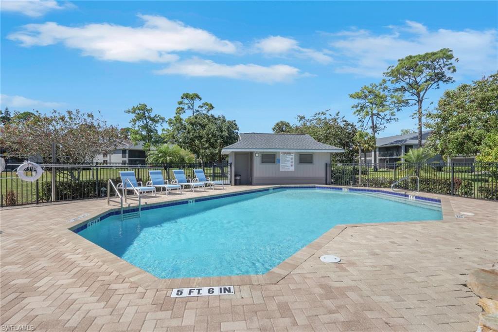 1211 Commonwealth Circle, Unit C201 Naples, FL 34116 - Photo 20 of 23 a view of a house with swimming pool and a porch