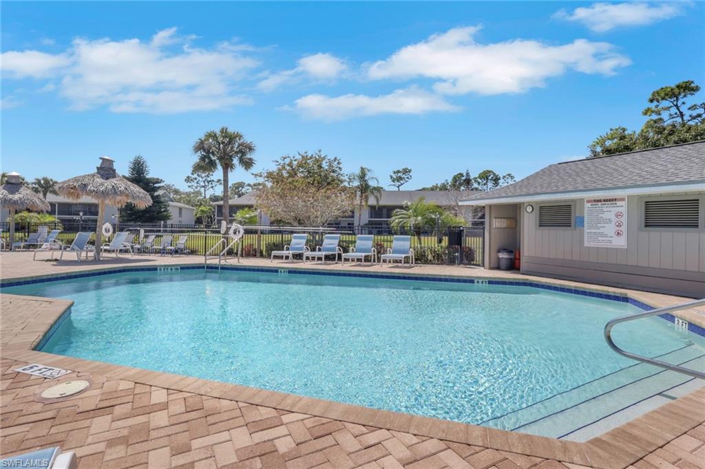 1211 Commonwealth Circle, Unit C201 Naples, FL 34116 - Photo 21 of 23 a view of a swimming pool with outdoor seating and plants
