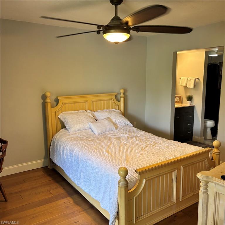 1211 Commonwealth Circle, Unit C201 Naples, FL 34116 - Photo 22 of 23 a bed sitting in a bedroom next to a window