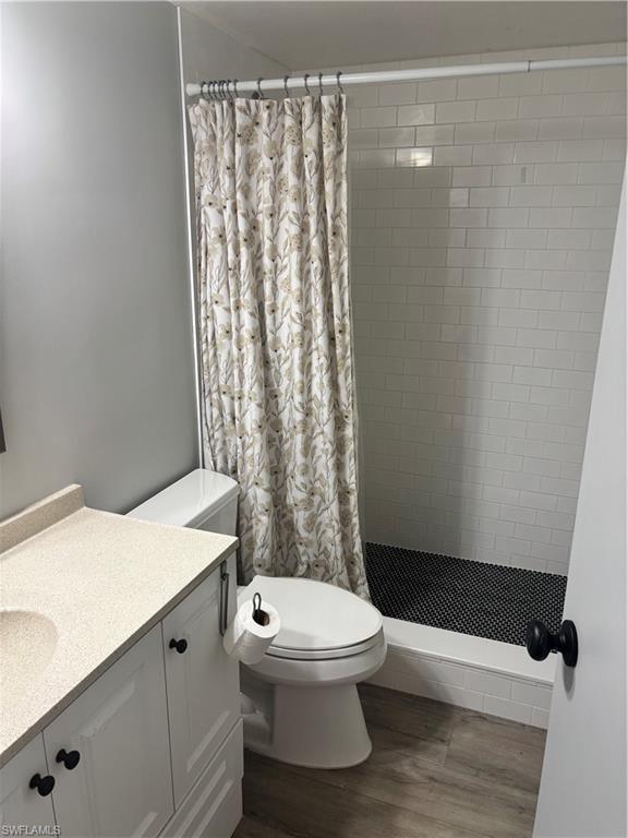 1211 Commonwealth Circle, Unit C201 Naples, FL 34116 - Photo 23 of 23 a bathroom with a toilet and a shower curtain