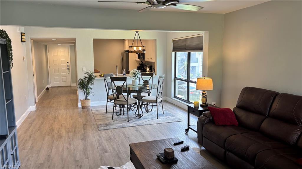 1211 Commonwealth Circle, Unit C201 Naples, FL 34116 - Photo 7 of 23 a living room with furniture and wooden floor