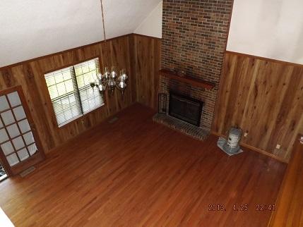 323 Spring Creek Road Lawrenceburg, TN 38464 - Photo 5 of 13 a view of a livingroom with furniture wooden floor and fireplace