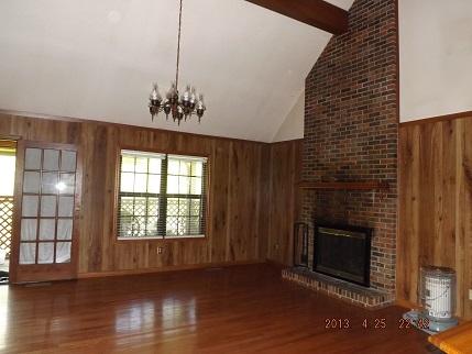 323 Spring Creek Road Lawrenceburg, TN 38464 - Photo 7 of 13 a view of a livingroom with a fireplace and wooden floor