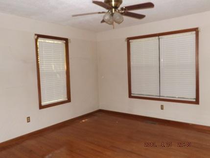 323 Spring Creek Road Lawrenceburg, TN 38464 - Photo 8 of 13 an empty room with wooden floor and windows