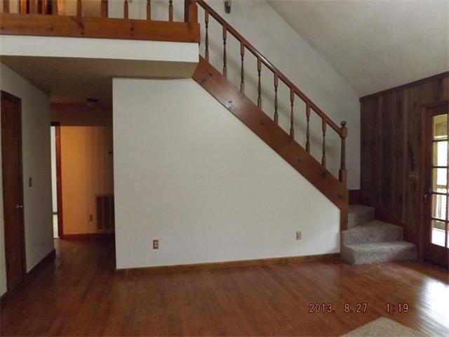 323 Spring Creek Road Lawrenceburg, TN 38464 - Photo 9 of 13 a view of a hallway with wooden floor and staircase