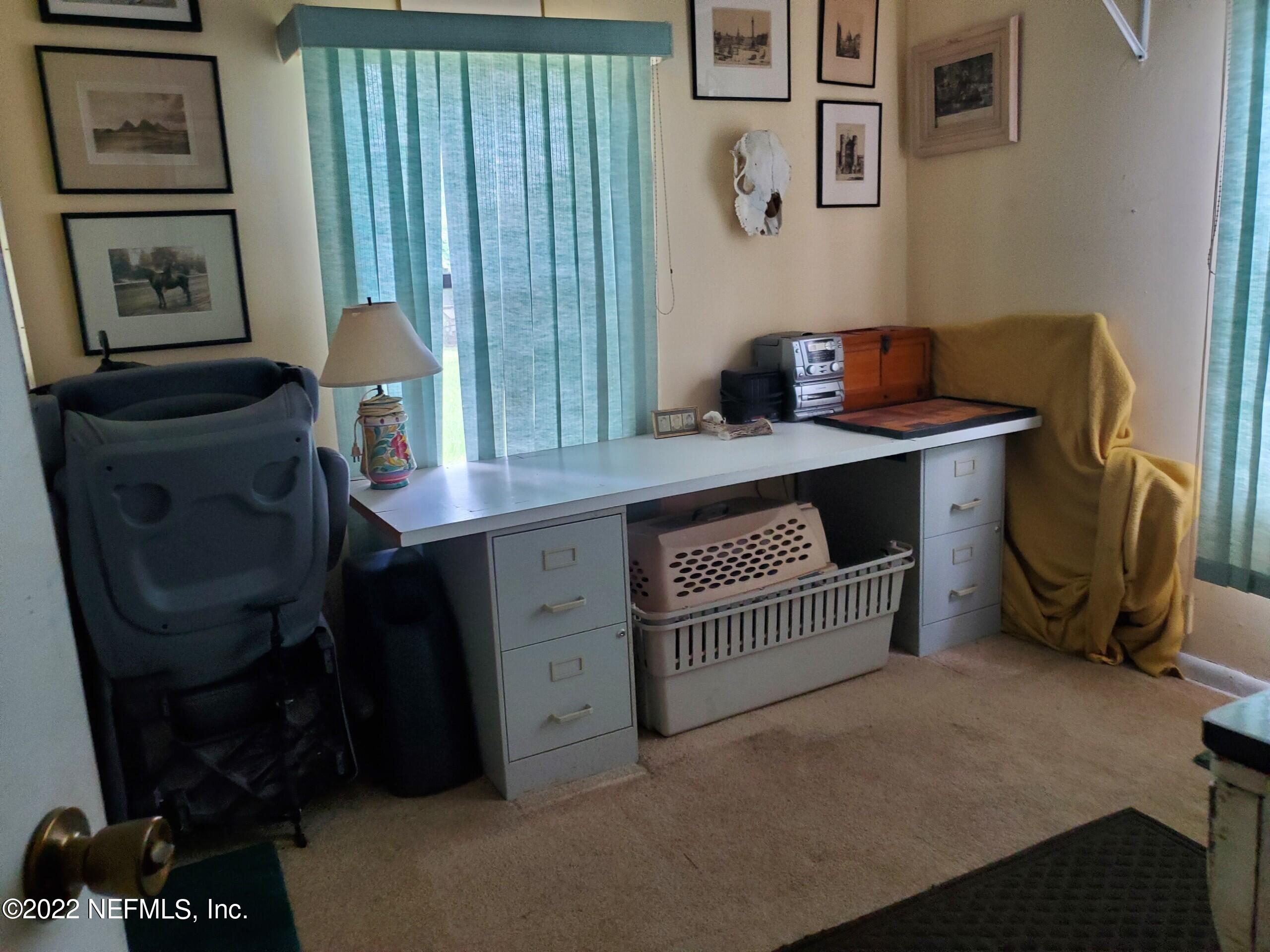 28 Jackson Road Atlantic Beach, FL 32233 - Photo 6 of 7 a bedroom with a bed and a desk