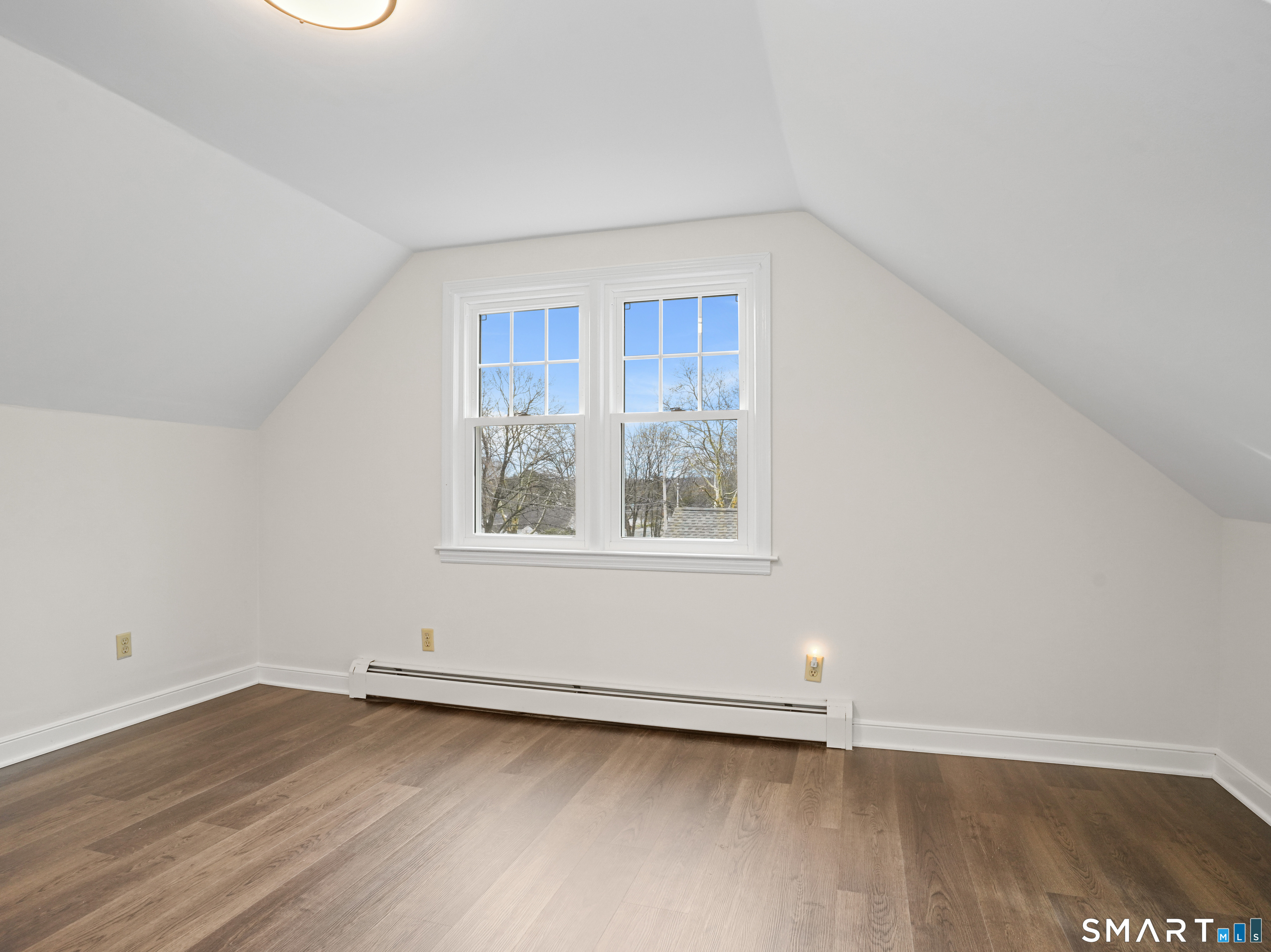 8 Raleigh Road Bridgeport, CT 06606 - Photo 12 of 20 an empty room with wooden floor and windows