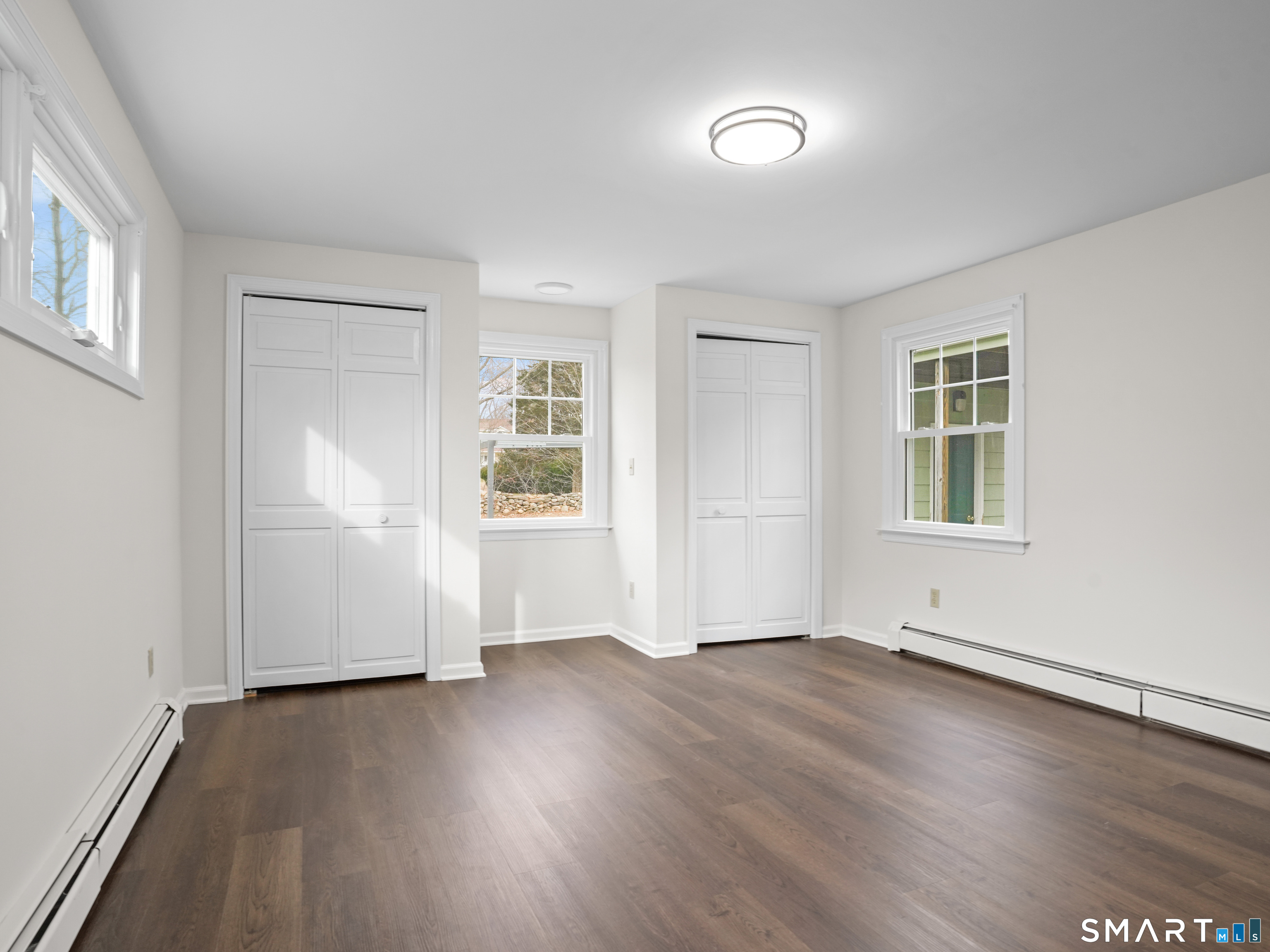 8 Raleigh Road Bridgeport, CT 06606 - Photo 13 of 20 an empty room with wooden floor and windows