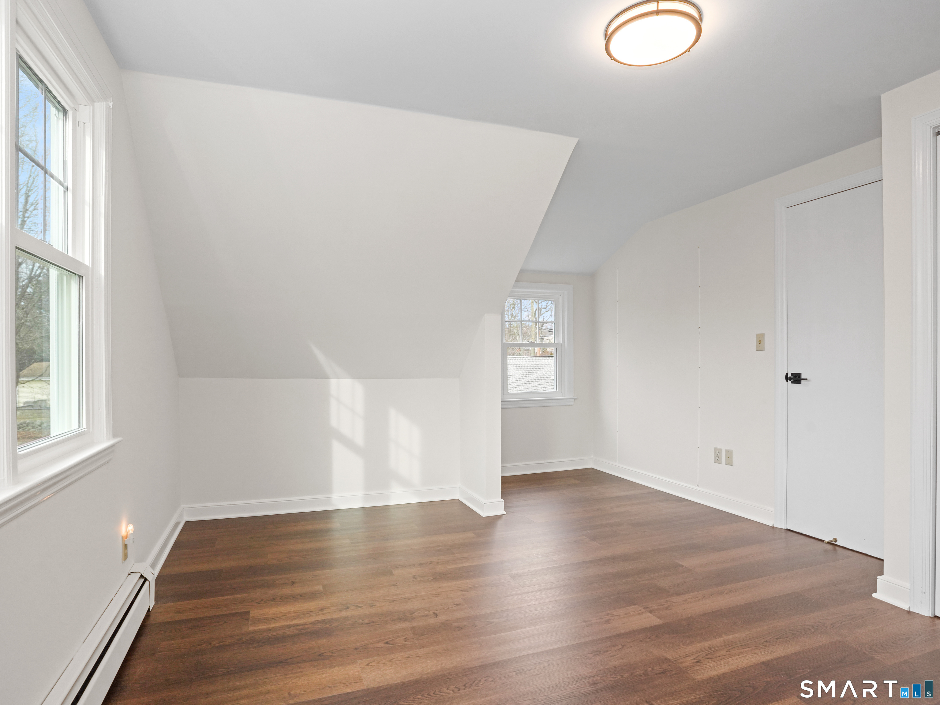 8 Raleigh Road Bridgeport, CT 06606 - Photo 15 of 20 an empty room with wooden floor and windows