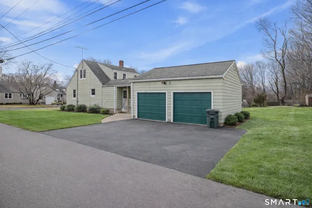 a view of a house with a yard and garage