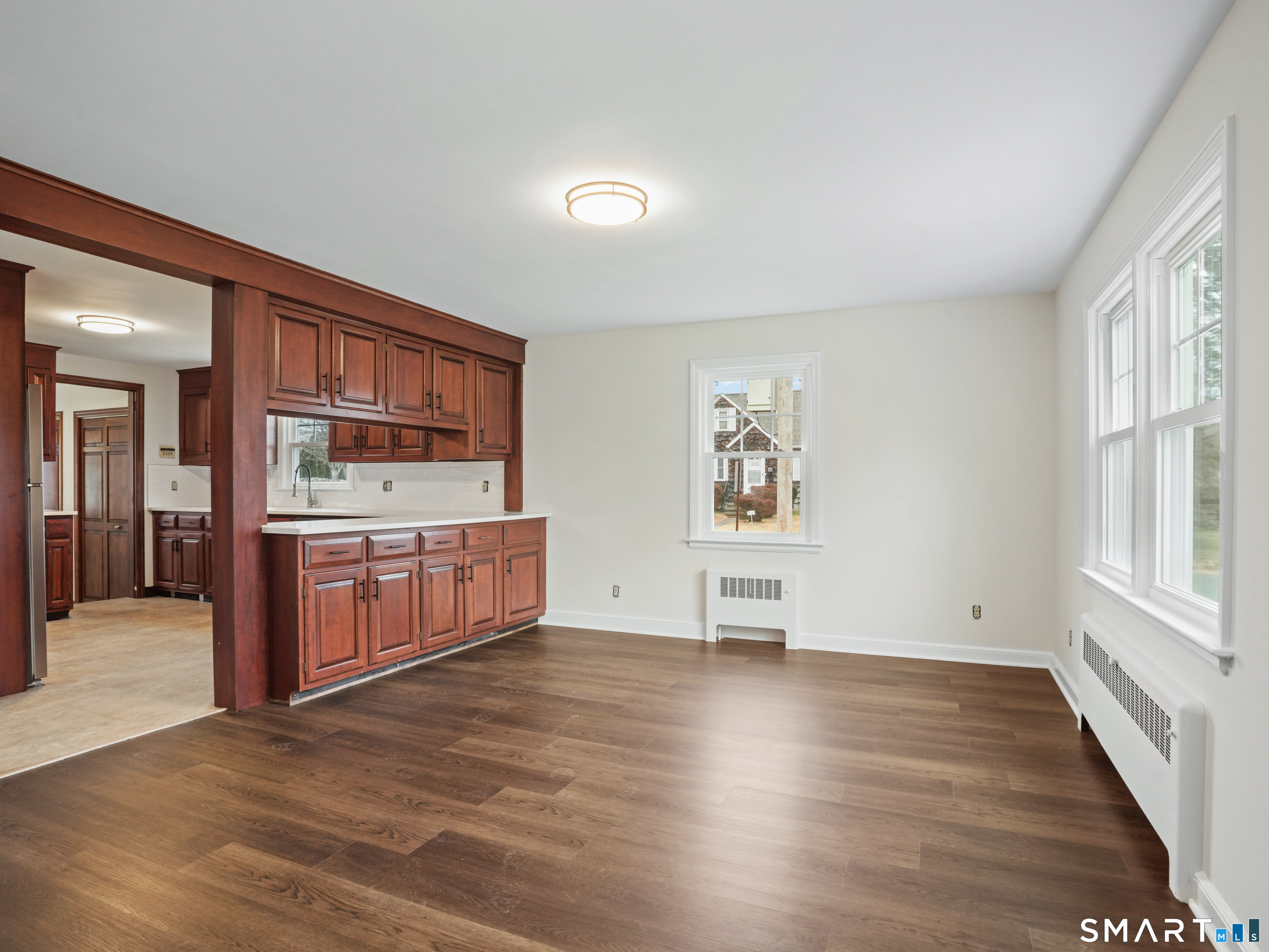 8 Raleigh Road Bridgeport, CT 06606 - Photo 5 of 20 an empty room with wooden floor and windows