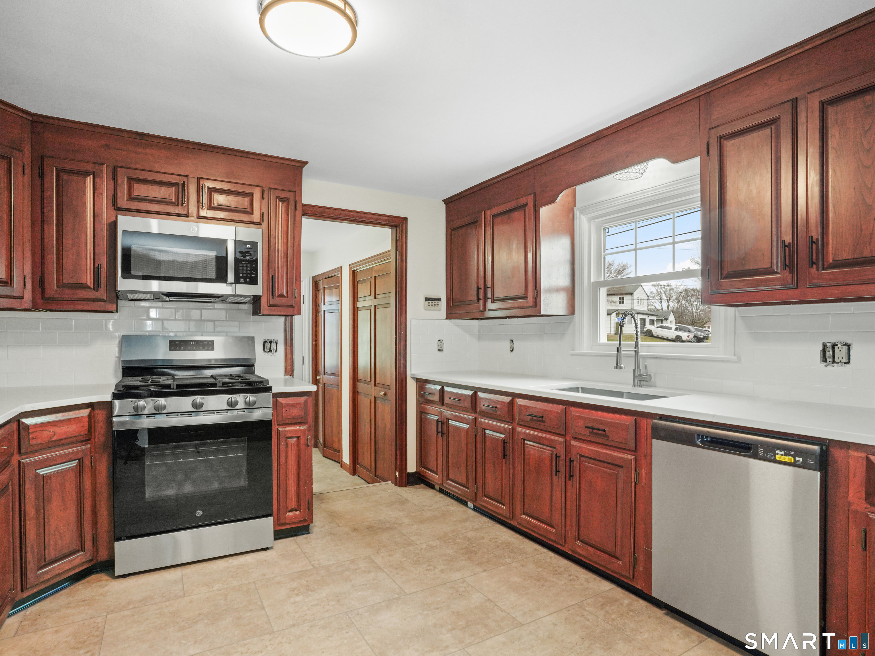 8 Raleigh Road Bridgeport, CT 06606 - Photo 6 of 20 a kitchen with stainless steel appliances granite countertop a stove microwave and sink