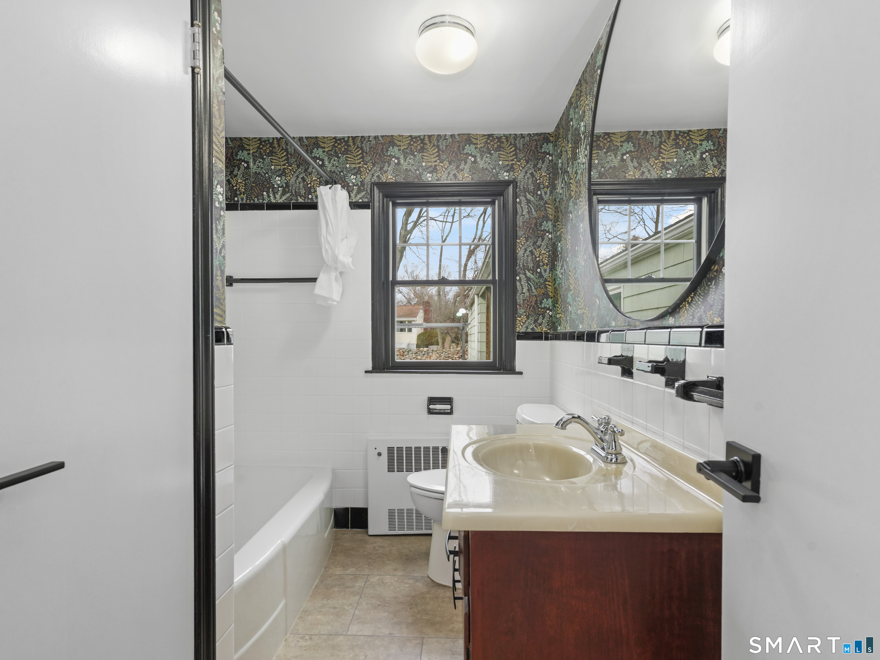 8 Raleigh Road Bridgeport, CT 06606 - Photo 8 of 20 a bathroom with a sink and a mirror