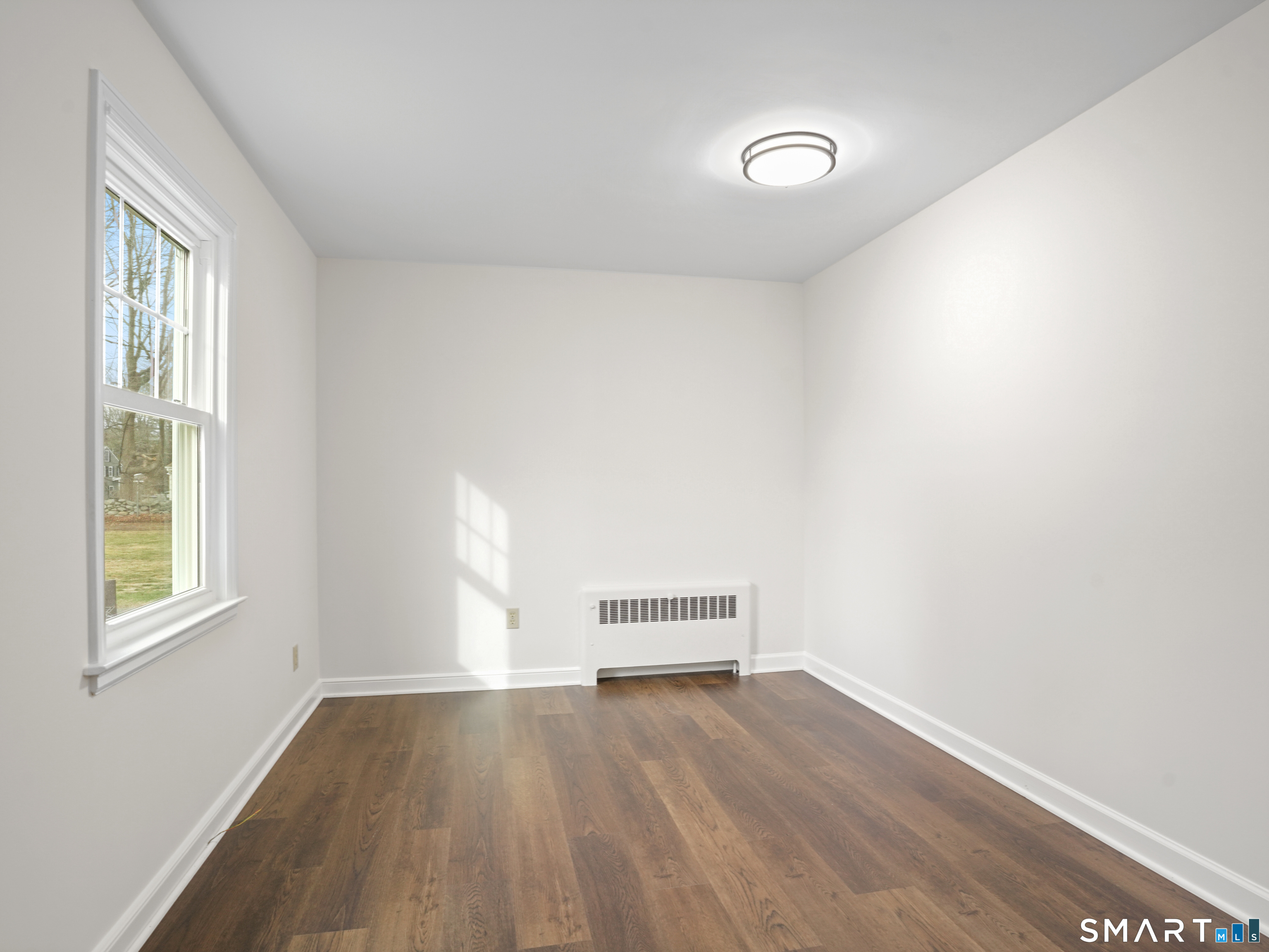 8 Raleigh Road Bridgeport, CT 06606 - Photo 10 of 20 a view of empty room with wooden floor and fan