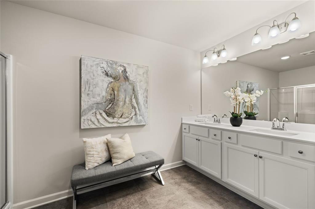 269 Epping Street, Unit 81 Stockbridge, GA 30281 - Photo 43 of 64 a en suite bathroom with a double vanity sink and a mirror