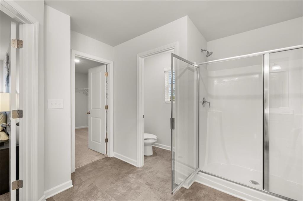 269 Epping Street, Unit 81 Stockbridge, GA 30281 - Photo 46 of 64 a bathroom with a shower and a toilet