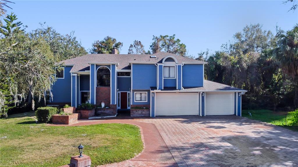 a view of a house with a yard and plants
